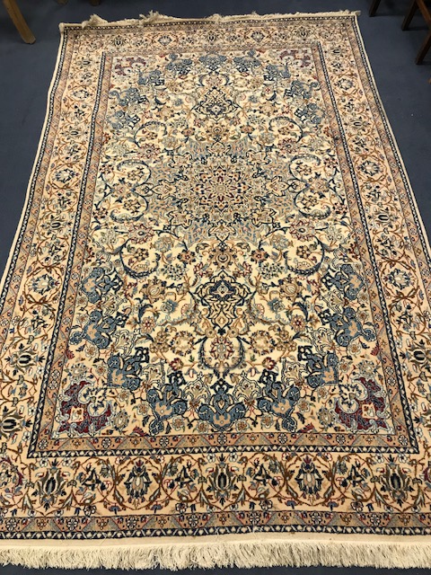 A Persian cream ground rug 270 x 165cm